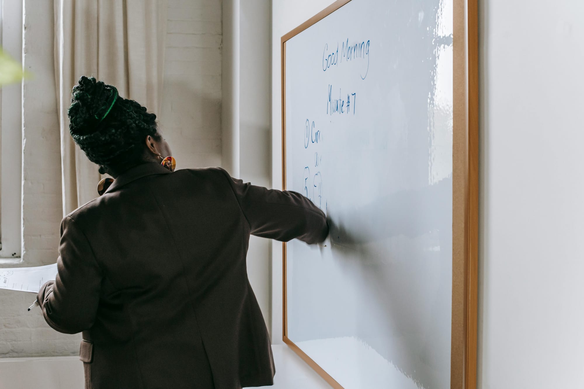A teacher giving a lecture on whiteboard